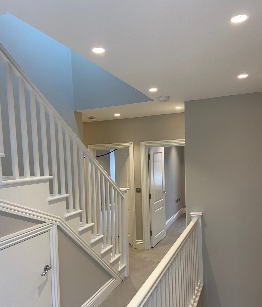 Bright, professionally painted hallway and staircase